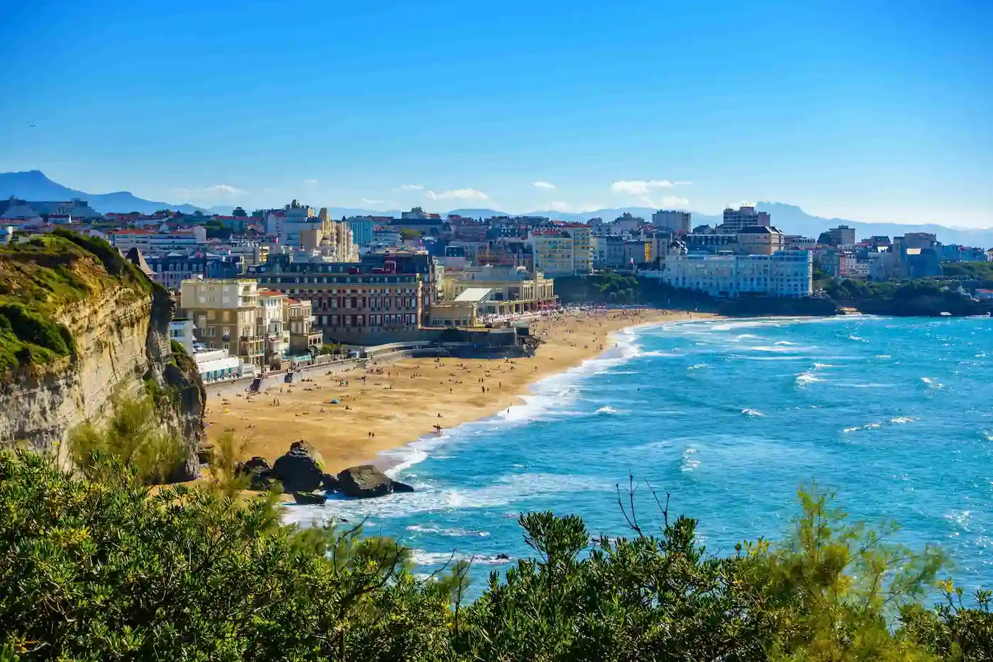 Vue panoramique d'une ville côtière ensoleillée illustrant la passion et le terroir du Bakery Bills Café